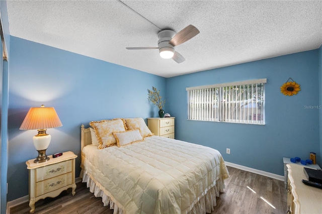 bedroom with dark hardwood / wood-style floors, a textured ceiling, and ceiling fan