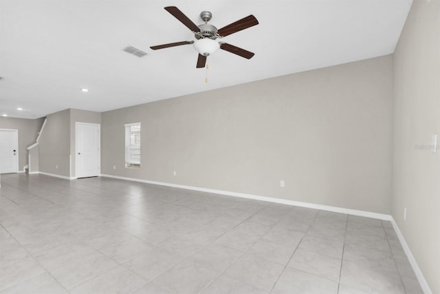 tiled spare room featuring ceiling fan