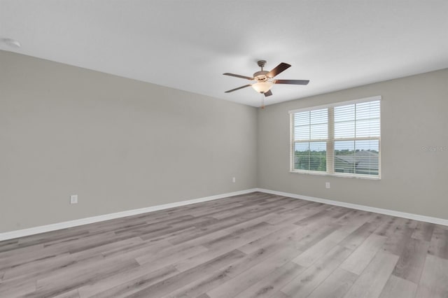 empty room with light hardwood / wood-style flooring and ceiling fan