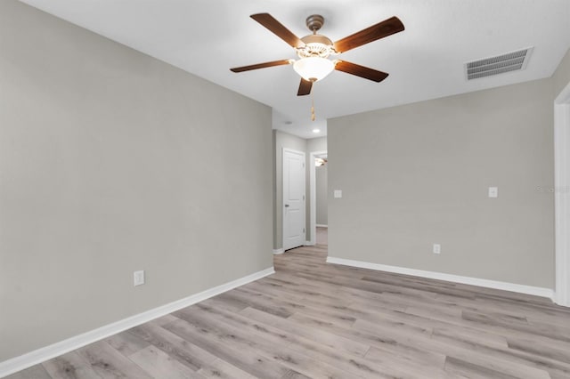 spare room featuring light wood-type flooring and ceiling fan