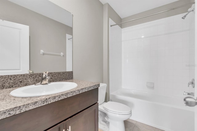 full bathroom with vanity, tiled shower / bath, toilet, and tile patterned floors