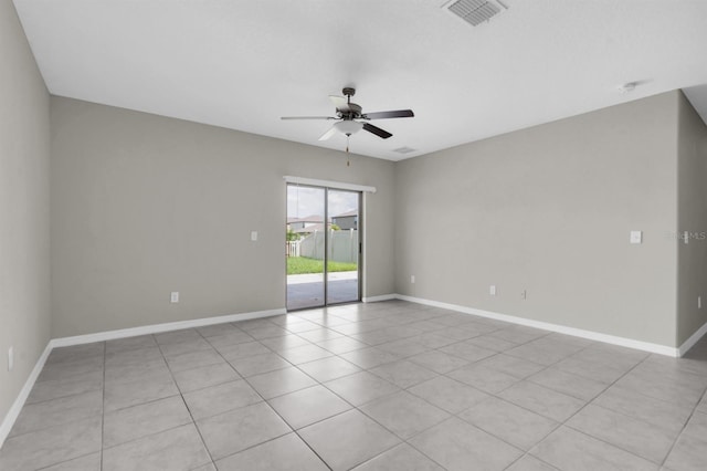 tiled spare room with ceiling fan