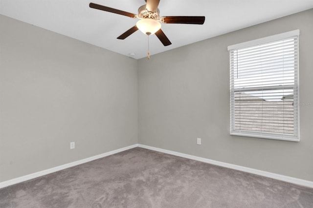 carpeted spare room featuring ceiling fan