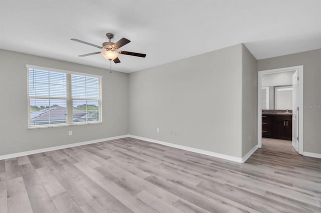 empty room with light wood-type flooring and ceiling fan