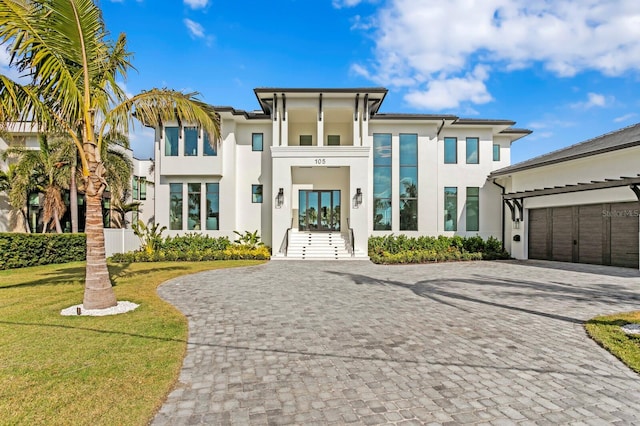 view of front of house with a garage and a front lawn