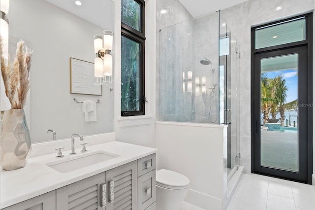 bathroom featuring walk in shower, vanity, and toilet