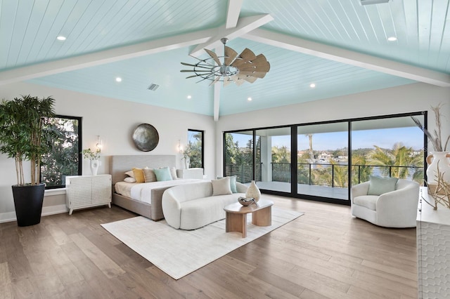 bedroom with multiple windows, access to exterior, and hardwood / wood-style flooring