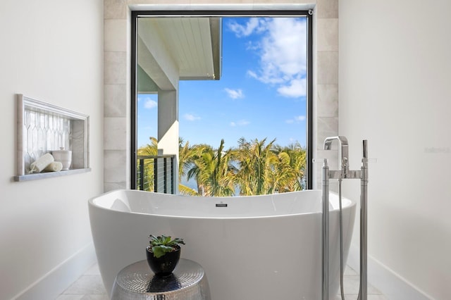 bathroom with tile patterned flooring and a bathing tub