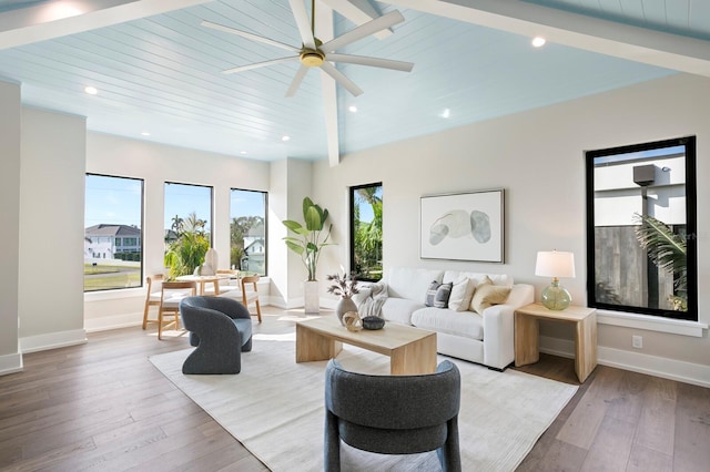 living room featuring ceiling fan, beam ceiling, and light hardwood / wood-style floors