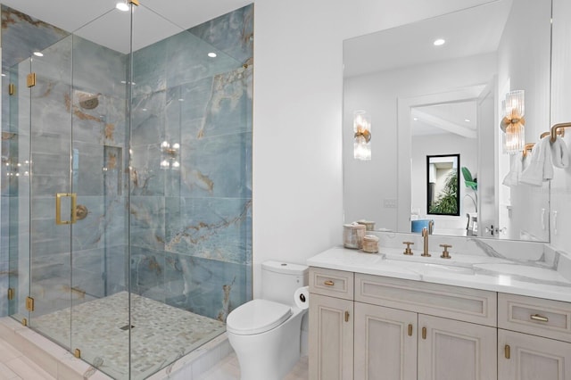 bathroom featuring vanity, a shower with door, and toilet