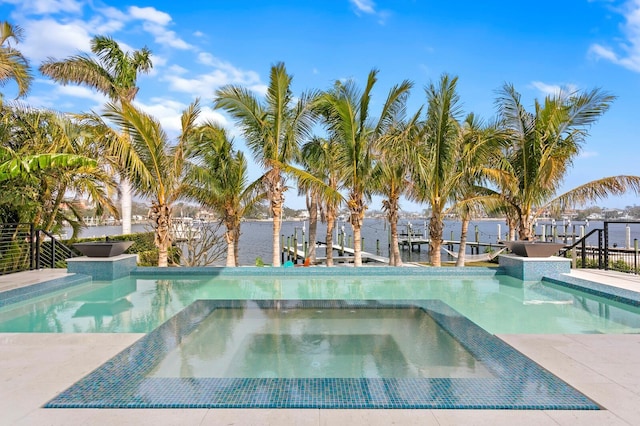 view of pool with an in ground hot tub and a water view