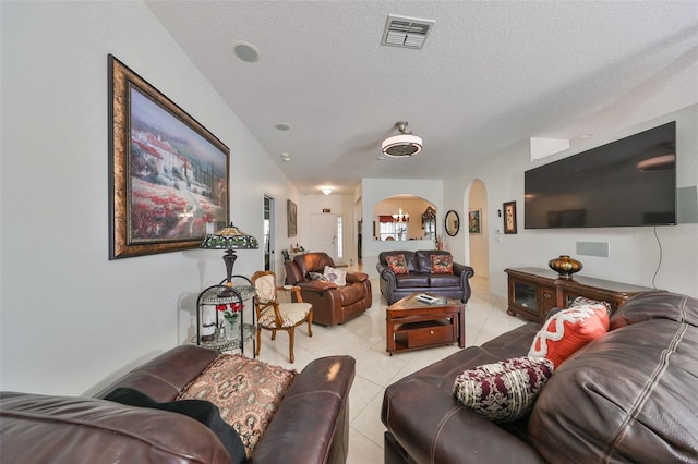 living room with a textured ceiling and light tile patterned floors