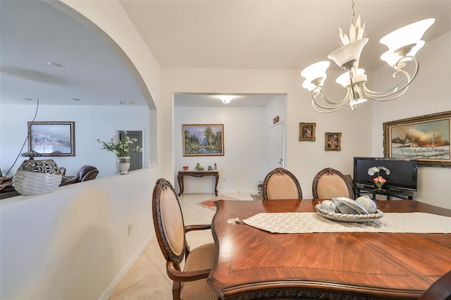 tiled dining area featuring a chandelier