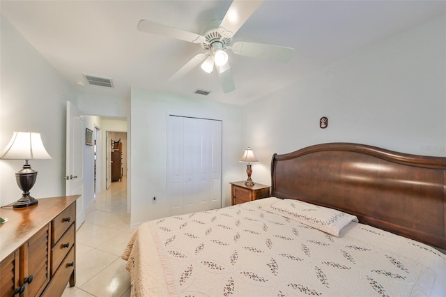 tiled bedroom with a closet and ceiling fan