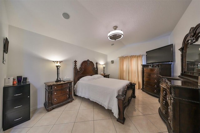 tiled bedroom with lofted ceiling