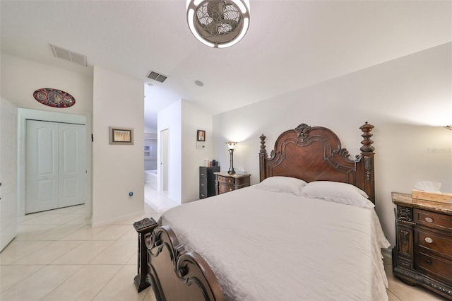 bedroom with vaulted ceiling and light tile patterned flooring