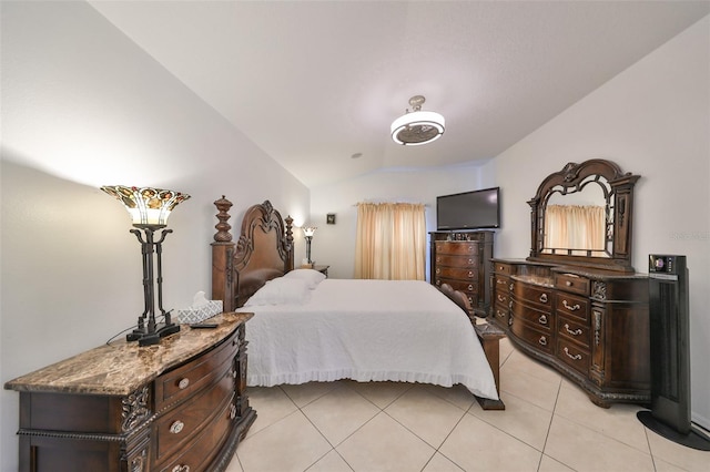 tiled bedroom featuring vaulted ceiling