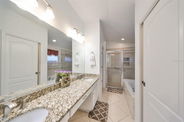 bathroom featuring vanity, independent shower and bath, lofted ceiling, and tile patterned flooring