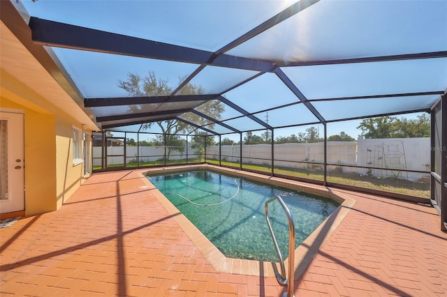 view of swimming pool with a patio area and glass enclosure