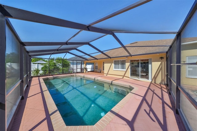 view of pool featuring a patio area and glass enclosure