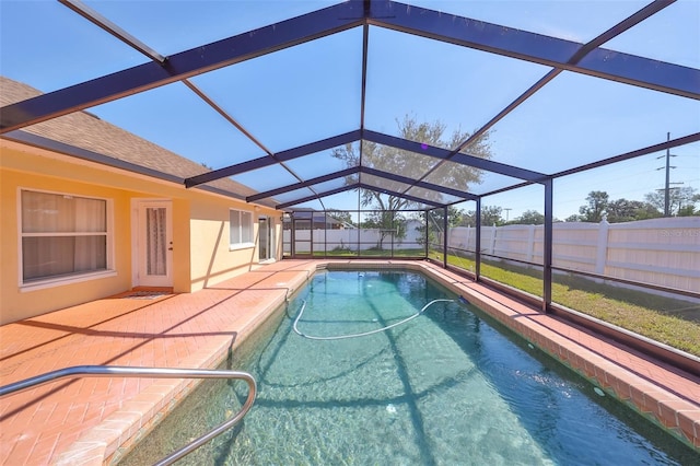 view of swimming pool with a patio and a lanai