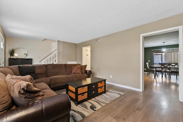 living room featuring hardwood / wood-style floors and a textured ceiling