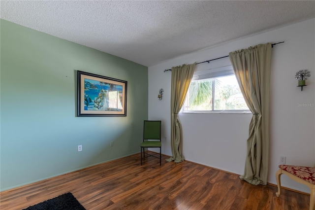 90 S Highland Ave Unit 1115, Tarpon Springs, FL 34689 - living area featuring a textured ceiling and wood finished floors