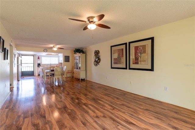 unfurnished living room featuring a textured ceiling, hardwood / wood-style flooring, and ceiling fan