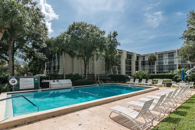 view of swimming pool featuring a patio area