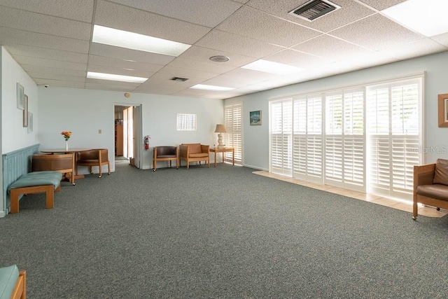 unfurnished room featuring a paneled ceiling and carpet floors