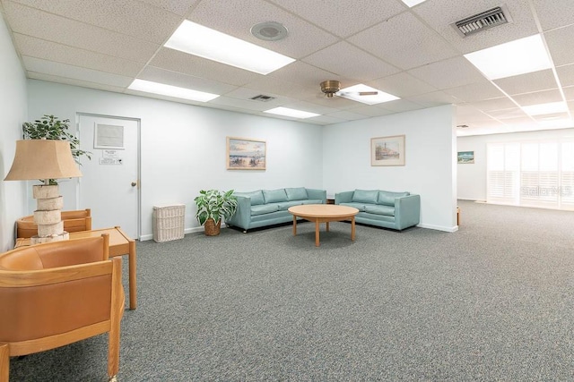 living room with carpet and a paneled ceiling