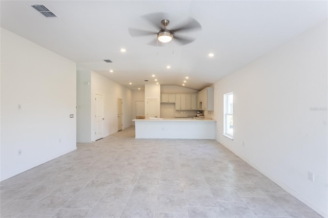 unfurnished living room featuring ceiling fan and lofted ceiling