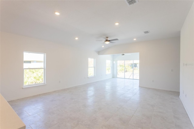 spare room featuring a wealth of natural light, light tile patterned floors, ceiling fan, and lofted ceiling