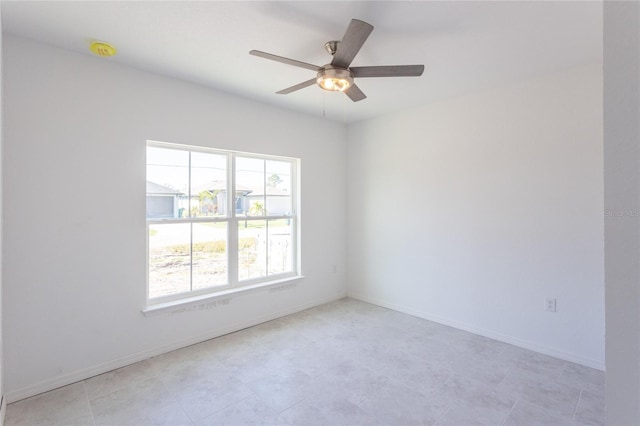 empty room featuring ceiling fan and a healthy amount of sunlight