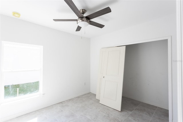 unfurnished bedroom featuring ceiling fan