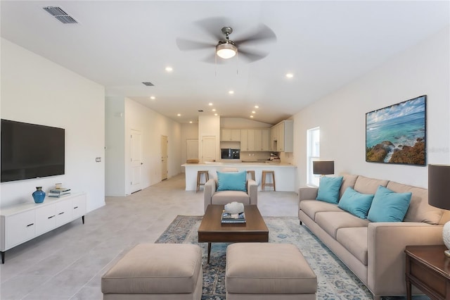 living room with ceiling fan and lofted ceiling