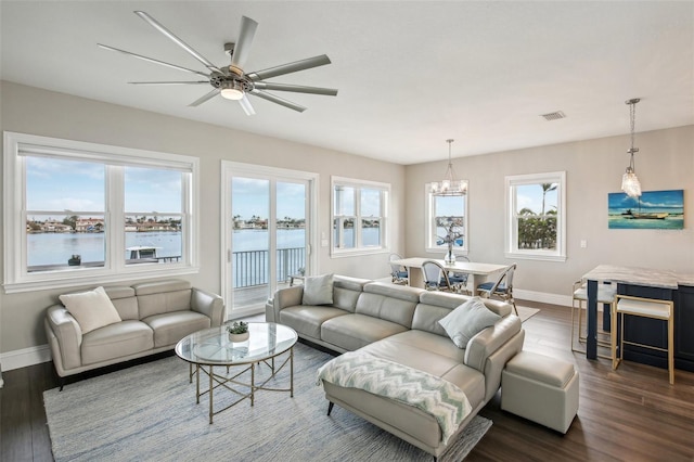 339 55th Ave, St Pete Beach, FL 33706 - living area with baseboards, dark wood-style floors, a ceiling fan, and a chandelier