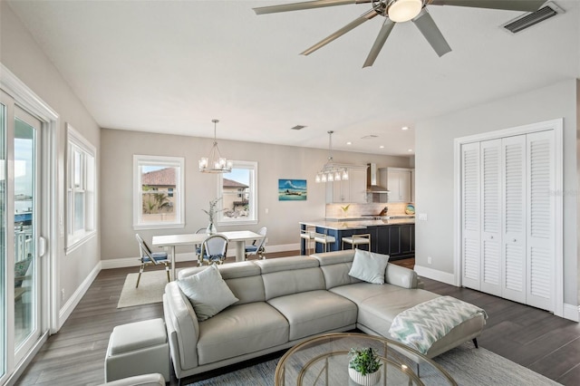 339 55th Ave, St Pete Beach, FL 33706 - living room featuring dark wood-style flooring, baseboards, a chandelier, recessed lighting, and ceiling fan