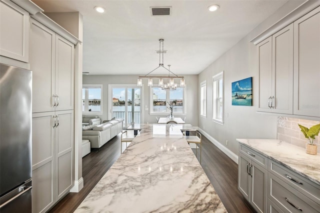 339 55th Ave, St Pete Beach, FL 33706 - dining room with plenty of natural light, dark wood-type flooring, recessed lighting, baseboards, and a water view