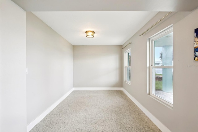 339 55th Ave, St Pete Beach, FL 33706 - spare room featuring speckle patterned floor and baseboards