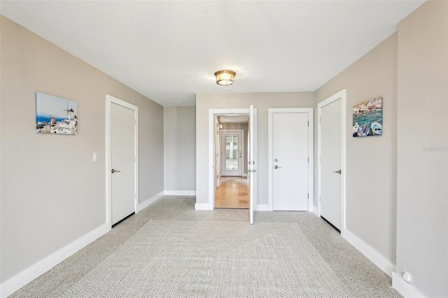 339 55th Ave, St Pete Beach, FL 33706 - empty room with baseboards and light colored carpet