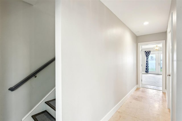339 55th Ave, St Pete Beach, FL 33706 - hall featuring baseboards and an upstairs landing