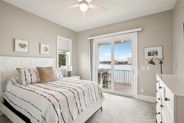339 55th Ave, St Pete Beach, FL 33706 - bedroom featuring light carpet, access to outside, baseboards, a water view, and a ceiling fan