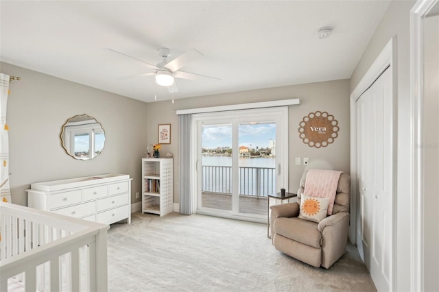 339 55th Ave, St Pete Beach, FL 33706 - bedroom featuring light colored carpet, a water view, baseboards, access to outside, and ceiling fan
