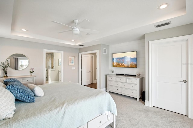 339 55th Ave, St Pete Beach, FL 33706 - bedroom with a tray ceiling, recessed lighting, light carpet, ensuite bath, and a ceiling fan