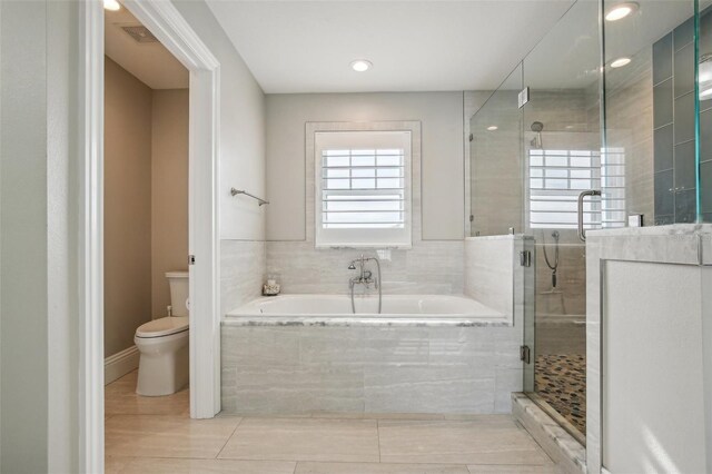 339 55th Ave, St Pete Beach, FL 33706 - bathroom featuring a garden tub, toilet, a shower stall, and recessed lighting