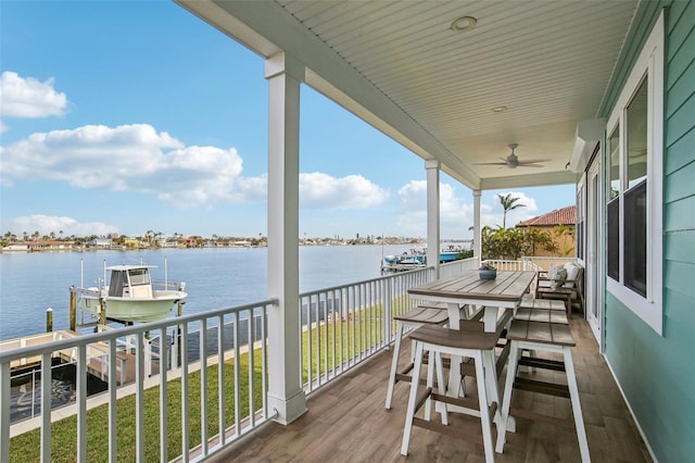 339 55th Ave, St Pete Beach, FL 33706 - wooden terrace with a water view, a ceiling fan, boat lift, and a boat dock