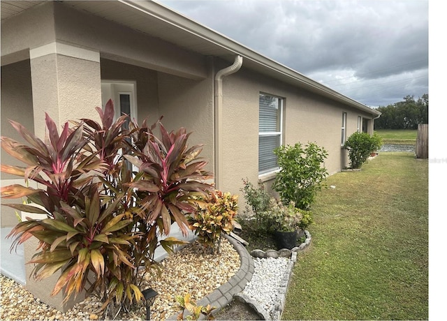 view of side of home with a lawn