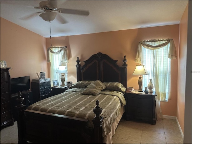 tiled bedroom featuring ceiling fan