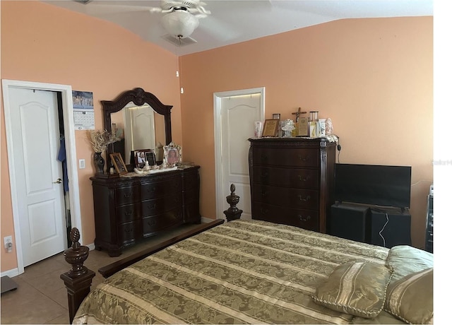 bedroom with ceiling fan, vaulted ceiling, and light tile patterned floors